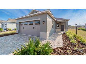 Inviting single-Gathering home featuring a two-car garage and well-maintained landscaping at 10277 Sw 96Th Loop, Ocala, FL 34481