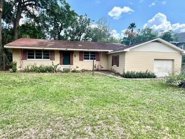 Charming single-story home featuring an attached garage and well-established lawn at 2220 Ne 3Rd St, Ocala, FL 34470