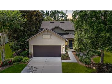 Charming home with a two-car garage, complemented by lush landscaping and a welcoming walkway at 9170 Sw 65Th Loop, Ocala, FL 34481