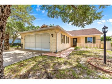 Charming single-story brick home with a two-car garage and well-maintained landscaping at 9266 Sw 91St Cir, Ocala, FL 34481