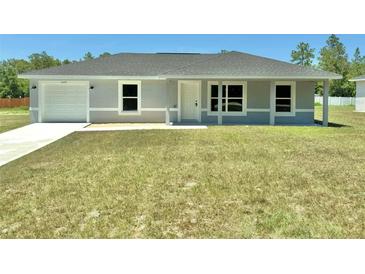Charming single-story home featuring a well-maintained lawn and an attached one car garage at 14437 Sw 21St Pl, Ocala, FL 34481
