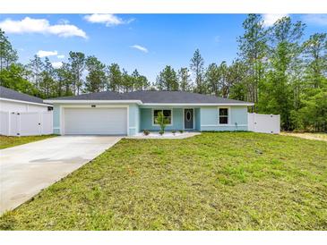 Charming single-story home featuring a fresh lawn, a two-car garage, and decorative landscaping at 15368 Sw 30Th St, Ocala, FL 34481