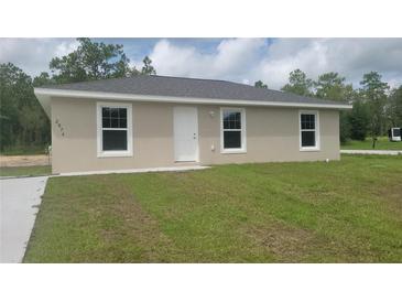 Charming single-story home featuring a new roof, fresh paint, and a well-maintained front yard at 20443 Sw Rainbow Lakes Blvd, Dunnellon, FL 34431