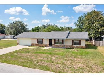 Charming single-story home featuring stone accents, a well-maintained lawn, and an attached one-car garage at 4331 Se 106Th Pl, Belleview, FL 34420