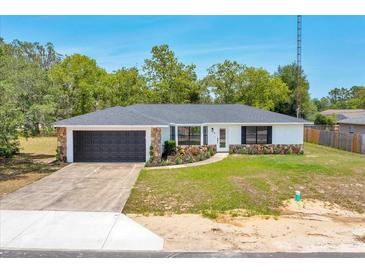 Charming single-story home with stone accents, well-maintained lawn, and attached garage at 6 Bahia Circle Loop, Ocala, FL 34472