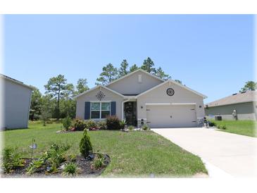 Charming single Gathering home with a well-maintained front yard and two car garage at 96 Hickory Crse, Ocala, FL 34472