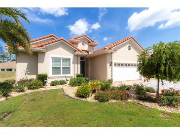 Charming single-story home with a terracotta tile roof and lush landscaping at 7210 Sw 179 Ct, Dunnellon, FL 34432