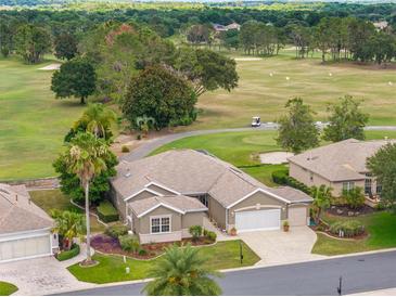 Beautiful home boasts lush landscaping and golf course views in a desirable community at 13495 Se 93Rd Court Rd, Summerfield, FL 34491