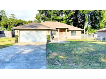 Charming single-story home featuring a well-maintained lawn, attached two car garage and a welcoming front entrance at 5263 Nw 62Nd Nw Ave, Ocala, FL 34482