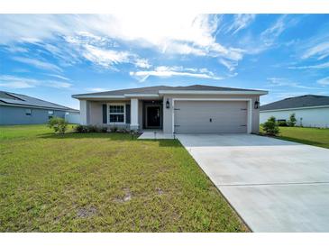 Charming single-story home with a well-manicured lawn and attached two-car garage at 8943 Se 41St Court Rd, Ocala, FL 34480