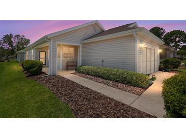 Charming one-story home with manicured lawn, neutral siding, and attached two-car garage at 9408 Se 132Nd Loop, Summerfield, FL 34491