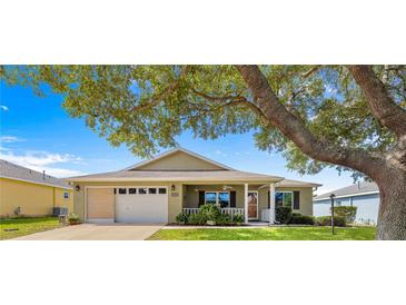 Charming single-story home featuring a well-maintained lawn and inviting front porch at 9750 Sw 97Th Pl, Ocala, FL 34481