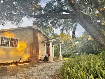 Charming home exterior featuring a quaint porch with white columns and a well-maintained landscaped front yard at 3005 Ne 19Th Ave, Ocala, FL 34479