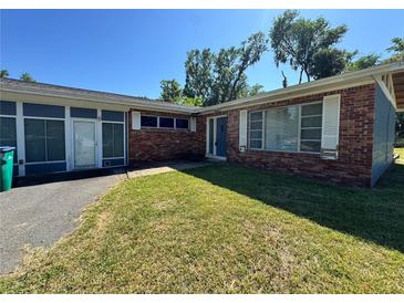 Charming single story home with red brick and a well-manicured lawn on a sunny day at 4000 Sw 6Th Ave, Ocala, FL 34471