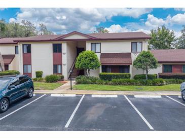 Attractive two-story condo with a parking lot, a walkway and landscaping in a well-maintained community at 688 Midway Dr # B, Ocala, FL 34472