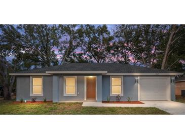 Charming single-story home with a well-maintained lawn and a front-facing two car garage at 13345 Sw 106 St, Dunnellon, FL 34432