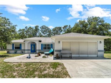Charming single-Gathering home features a well-manicured front yard and a two-car garage at 2698 Sw 186Th Ct, Dunnellon, FL 34432