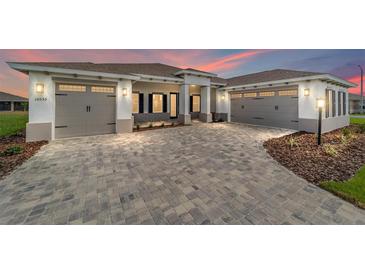 Charming two-car garage home with stone driveway, manicured garden, and welcoming curb appeal at 10553 Sw 98Th Pl, Ocala, FL 34481