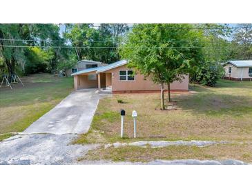 Charming single-story home with a covered carport and a well-maintained lawn at 1322 Ne 53Rd St, Ocala, FL 34479