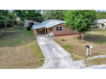 Charming single-story home featuring a covered carport and well-maintained front yard landscaping at 1322 Ne 53Rd St, Ocala, FL 34479