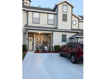 Charming two-story townhouse with a manicured lawn and a welcoming front porch at 231 Ne 28Th Ave # 207, Ocala, FL 34470