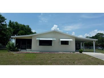 Charming single-story home with awnings and a well-maintained front lawn at 9960 Sw 103Rd Ln, Ocala, FL 34481