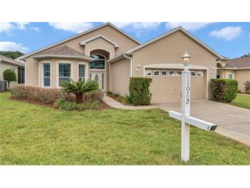 Charming single-story home with a well-maintained lawn, mature landscaping, and neutral stucco exterior at 11062 Sw 73Rd Ct, Ocala, FL 34476