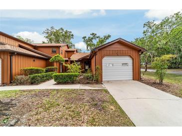 Charming exterior view of home, featuring a one car garage and well maintained landscaping at 2701 Ne 10Th St # 101, Ocala, FL 34470