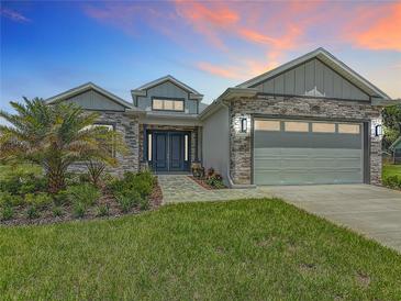 Beautiful single-Gathering home with stone accents, well-maintained landscaping, and a two-car garage at 4370 County Road 121D, Wildwood, FL 34785