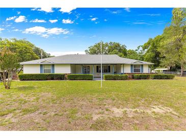 Charming one-story home with a well-maintained lawn and manicured hedges providing curb appeal at 4880 Ne 23 Ave, Ocala, FL 34479