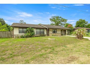 Charming single-story home featuring a well-maintained front yard, stone accents, and an attached garage at 5720 Se 20Th St, Ocala, FL 34480