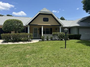 Charming single-story home with a well-manicured lawn and a welcoming front porch at 8801 Sw 92Nd St # B, Ocala, FL 34481