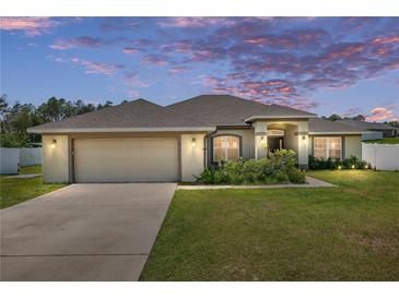 Charming single-story home with a well-manicured lawn, two-car garage, and inviting curb appeal at 10910 Sw 41St Ave, Ocala, FL 34476