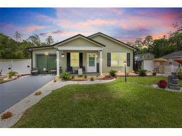 Charming single story home featuring a manicured lawn and attractive landscaping at 15324 Sw 40Th Place Rd, Ocala, FL 34481