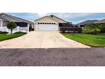 Charming single Gathering home featuring an attached garage and well-maintained landscaping at 3021 Beard Rd, The Villages, FL 32163