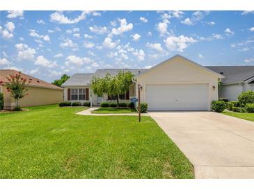 Charming single-story home with a well-manicured lawn and attached two-car garage at 3024 Burbank Ln, The Villages, FL 32162