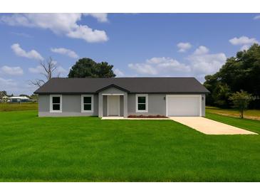 Charming one-story home featuring a well-maintained lawn and a single-car garage at 3529 Sw 150Th Ct, Dunnellon, FL 34432