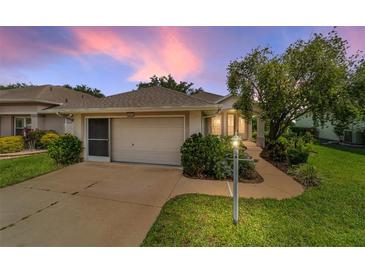 Charming single story home with a well-manicured lawn and 2 car garage at 5007 Kelso St, Leesburg, FL 34748