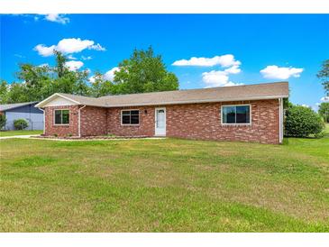 Charming single-story brick home with a well-maintained lawn and inviting entrance at 6989 Se 52Nd Pl, Ocala, FL 34472