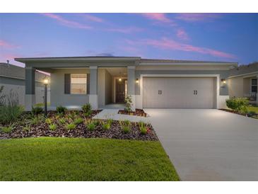 Beautiful home with a manicured lawn, covered entry, and attached two car garage at 7203 Sw 86Th Ave, Ocala, FL 34481