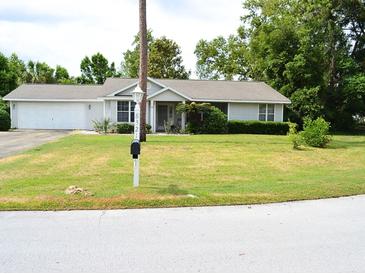 Charming single-story home with manicured lawn and attached garage, offering great curb appeal at 8321 Sw 108Th Place Rd, Ocala, FL 34481