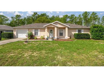 Charming single-story home featuring a well-manicured lawn and inviting front entrance at 9 Bahia Trace Loop, Ocala, FL 34472