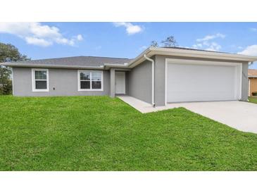 Charming single-story home featuring a well-manicured lawn and an attached one-car garage at 17277 Sw 44Th Cir, Ocala, FL 34473
