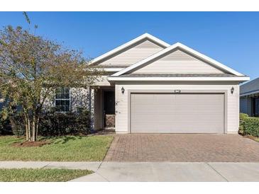 Charming single-story home featuring a two-car garage and manicured front lawn with a brick-paved driveway at 3947 Nw 46Th Ter, Ocala, FL 34482