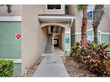 Exterior shot of building entrance with stairway and landscaping at 4897 Cypress Wood Dr # 6313, Orlando, FL 32811