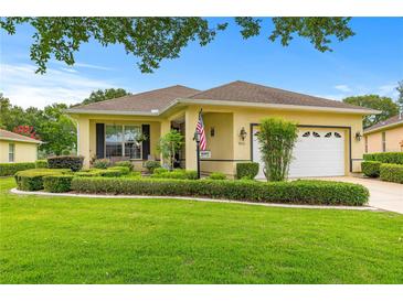 Charming single-story home with well-maintained landscaping and a lush green lawn at 9551 Sw 92Nd Ter, Ocala, FL 34481