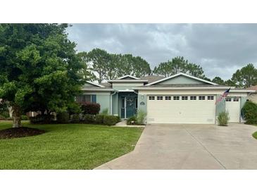 Charming single-story home with well-maintained landscaping, a large front lawn, and attached two-car garage at 16023 Sw 14Th Avenue Rd, Ocala, FL 34473