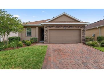 Charming single-Gathering home boasting a brick driveway and a two-car garage at 5587 Nw 40Th Pl, Ocala, FL 34482