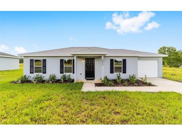 Charming single-story home features a well-manicured lawn and a welcoming front entrance at 6 Locust Loop Crse, Ocala, FL 34472
