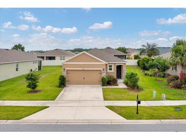 Charming single-Gathering home featuring a well-manicured lawn and a two-car garage at 6318 Sw 89Th Lane Rd, Ocala, FL 34476